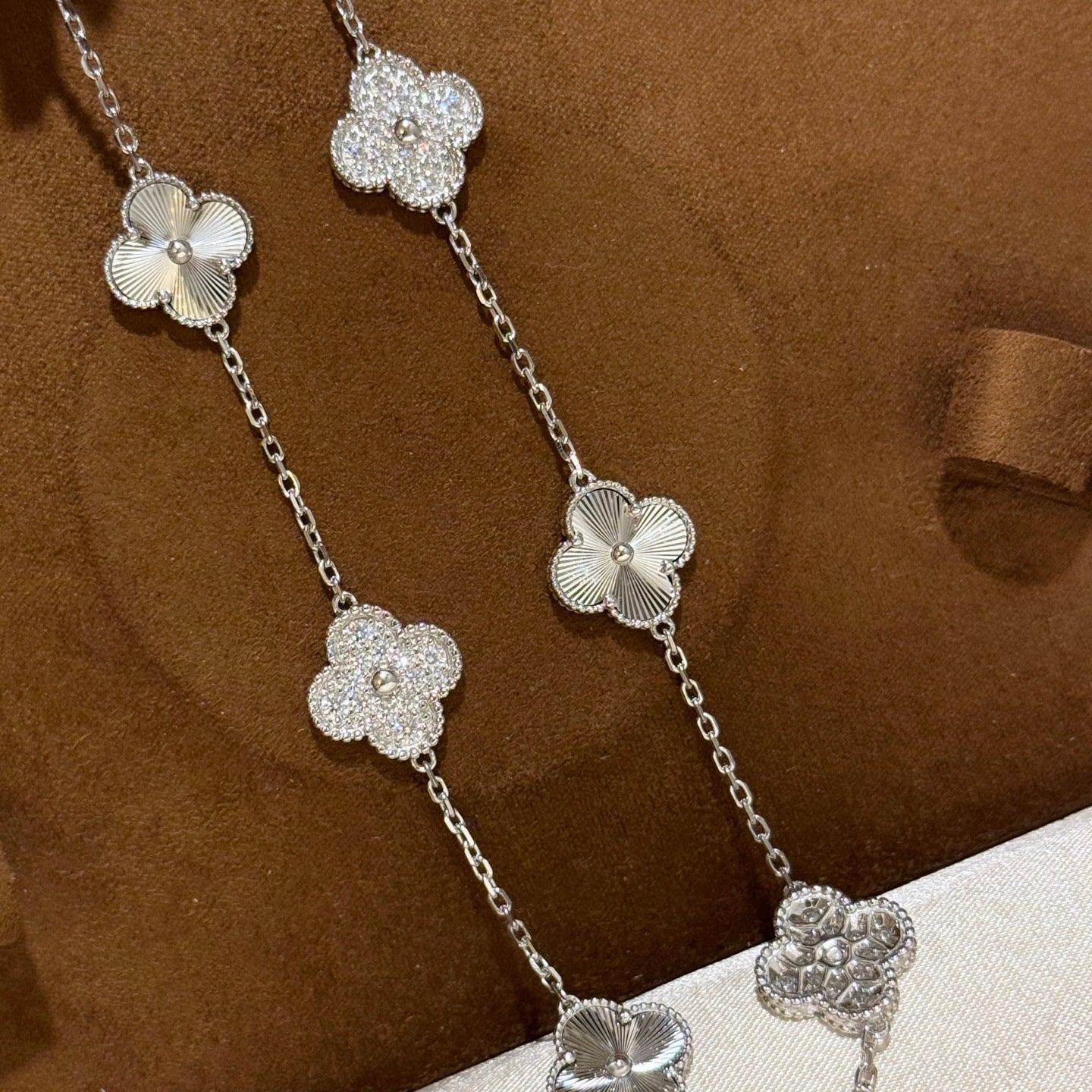 Laser-cut four-leaf clover necklace with interspersed diamonds and ten flowers